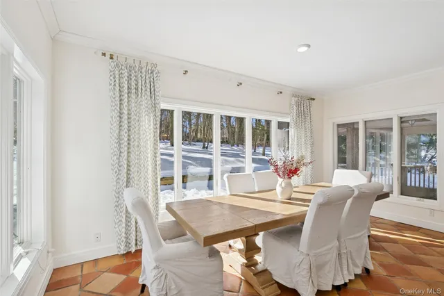 a dining room with furniture and window