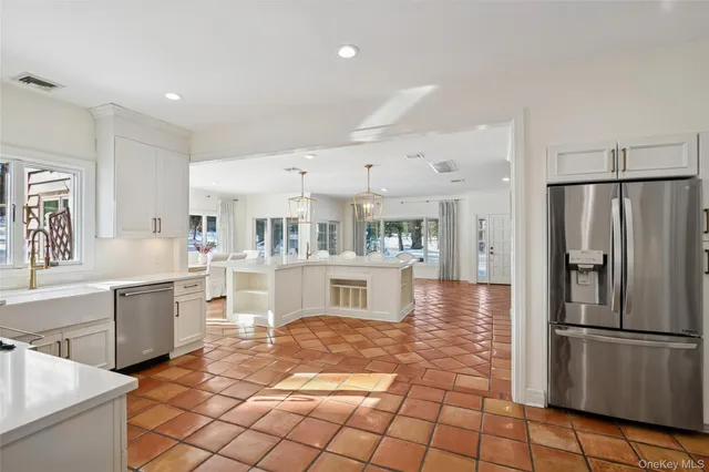 a kitchen with stainless steel appliances granite countertop a refrigerator and a sink