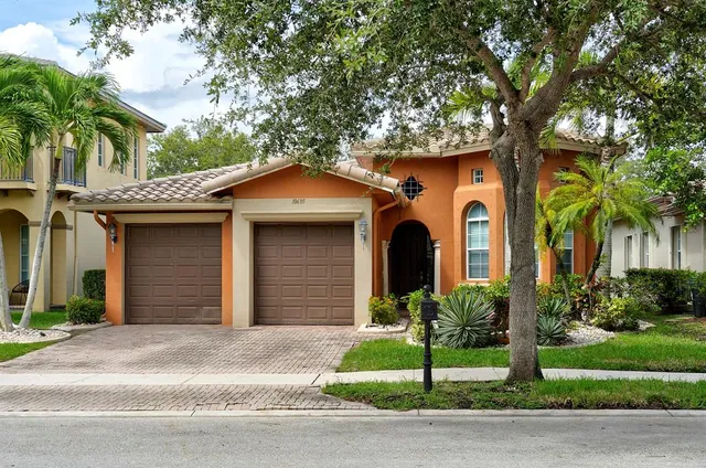 a front view of a house with a garden