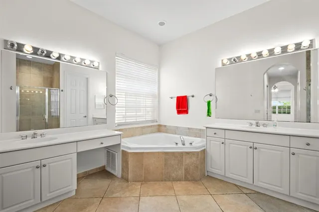a bathroom with a tub sink and mirror