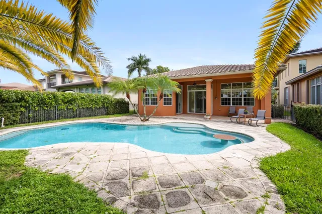 a front view of a house with swimming pool having outdoor seating