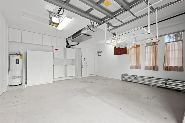 a front view of a house with a yard and potted plants