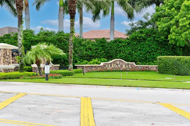 a view of a house with a yard and potted plants