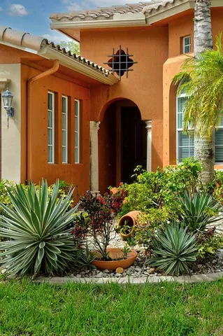 a front view of a house with a garden