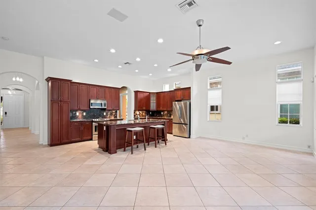 a view of kitchen with furniture and stainless steel appliances