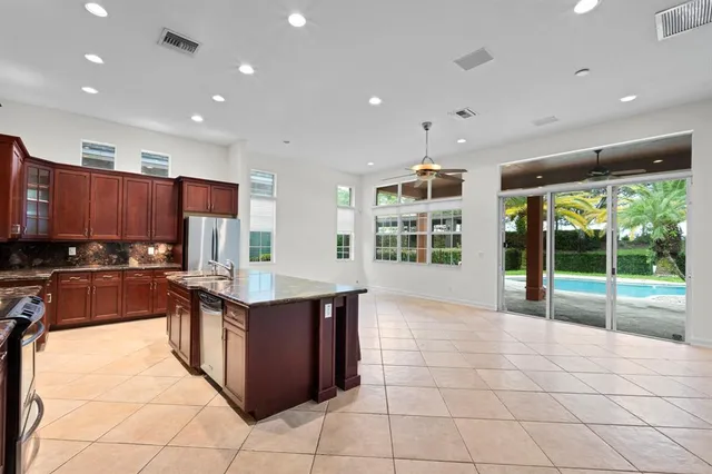 a kitchen with stainless steel appliances granite countertop a sink and a stove