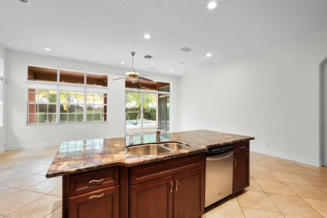 a kitchen with stainless steel appliances granite countertop a sink and a white cabinets