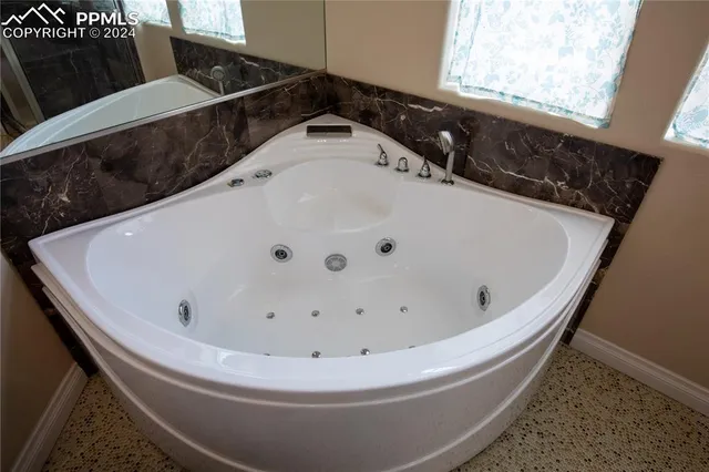 a white bath tub sitting in a bathroom