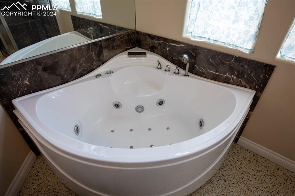 1510 York Road, Unit 103 Colorado Springs, CO 80918 - Photo 23 of 28 a white bath tub sitting in a bathroom