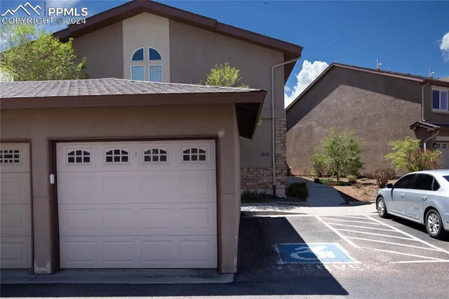 a view of a car park in front of a house