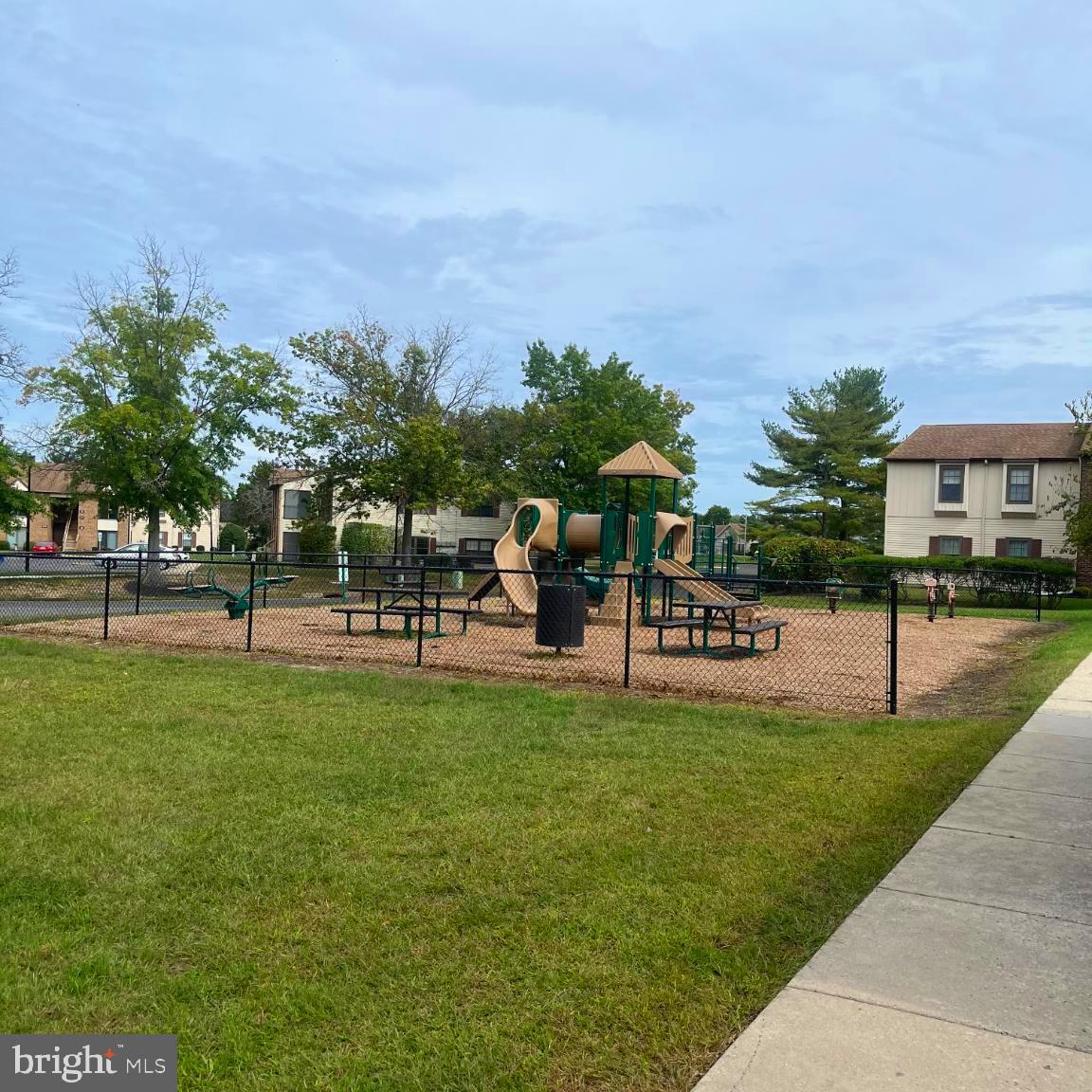 1 Windsor Court Sewell, NJ 08080 - Photo 5 of 21 a group of people sitting on a lawn chairs in front of a building
