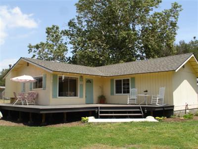 411 Burnham Road Oak View, CA 93022 - Photo 3 of 10 a front view of a house with a garden and yard