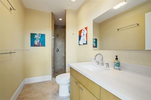 a bathroom with a sink vanity and toilet