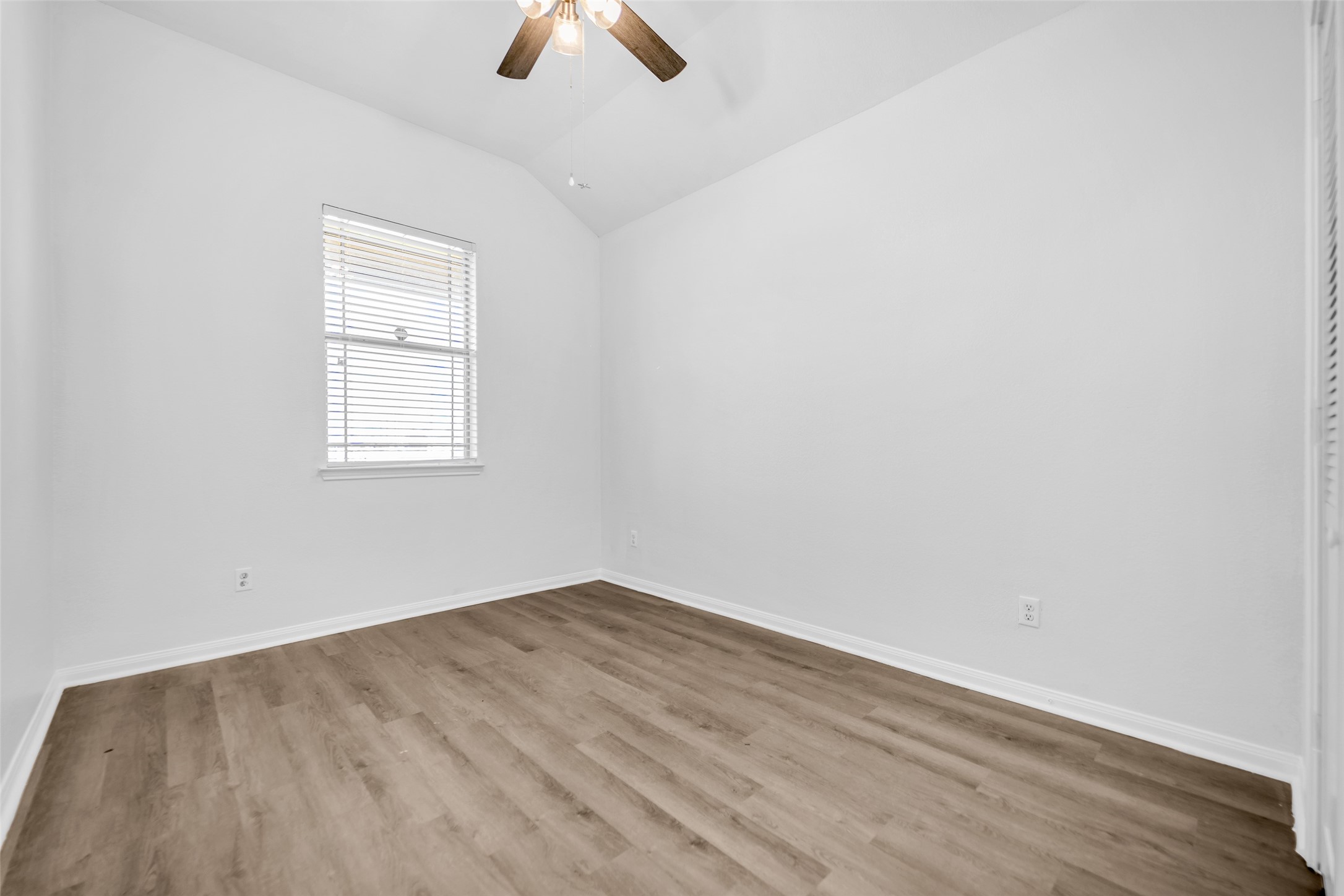 4707 Waukegan Road Conroe, TX 77306 - Photo 21 of 31 Secondary bedroom overlooks the front yard and features a ceiling fan for improved airflow, along
with vinyl flooring that adds durability and easy maintenance.