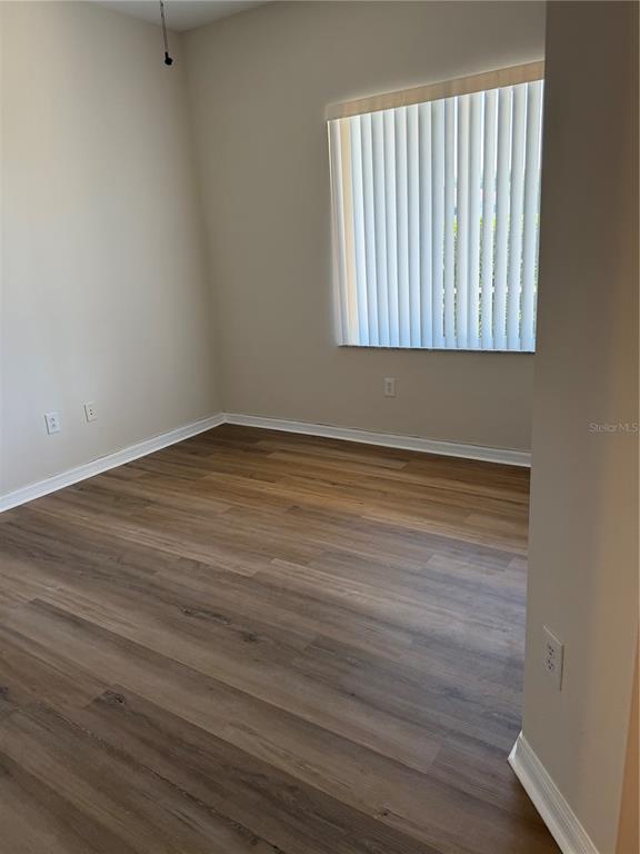 10760 Plantation Bay Drive Tampa, FL 33647 - Photo 11 of 39 a view of an empty room with wooden floor and a window