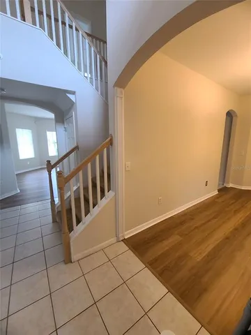 a view of staircase with white walls and railing