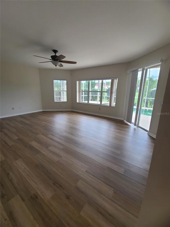 10760 Plantation Bay Drive Tampa, FL 33647 - Photo 7 of 39 an empty room with wooden floor and windows