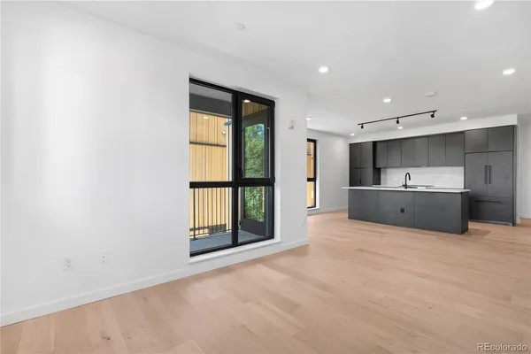 a view of kitchen with a sink and a refrigerator