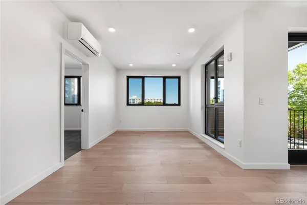 an empty room with windows and closet