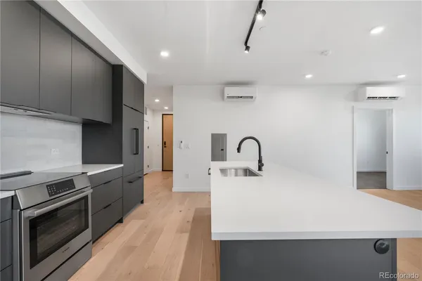 a kitchen with stainless steel appliances a stove sink and cabinets