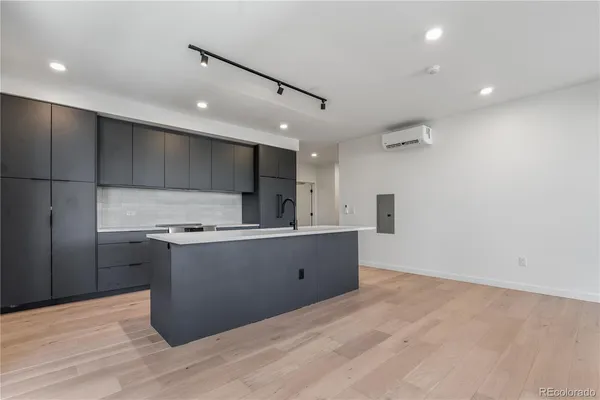 a kitchen with stainless steel appliances a refrigerator and a stove top oven