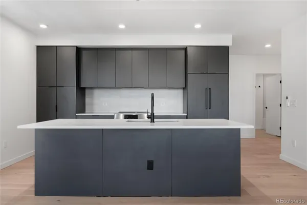 a kitchen with stainless steel appliances granite countertop a sink a refrigerator and a stove