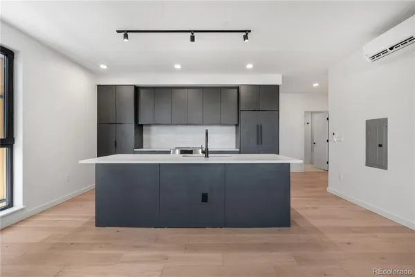 a view of kitchen with stainless steel appliances granite countertop a sink a refrigerator and a stove