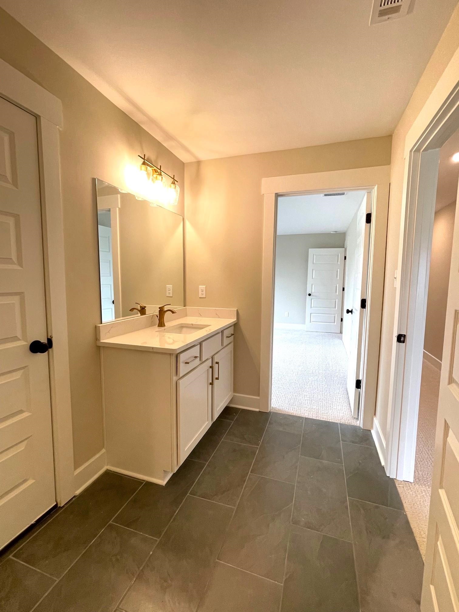 11150 Shelby Post Road Collierville, TN 38017 - Photo 22 of 25 a bathroom with a sink a mirror and a vanity