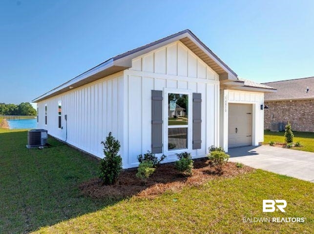 16810 Rocher Court Foley, AL 36535 - Photo 2 of 24 White board and batten siding exterior featuring a grey shingle roof and grey window shutters