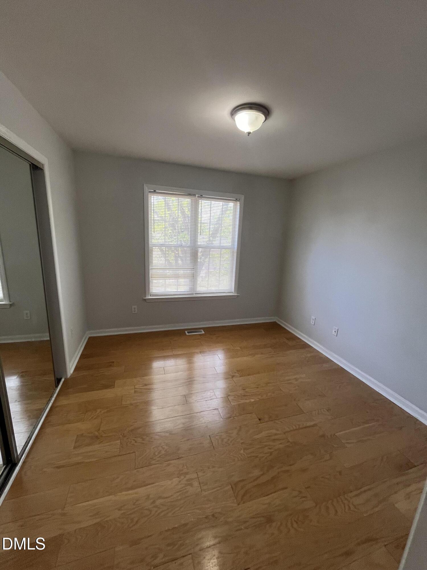 2036 Turtle Point Drive Raleigh, NC 27604 - Photo 11 of 29 an empty room with wooden floor and windows
