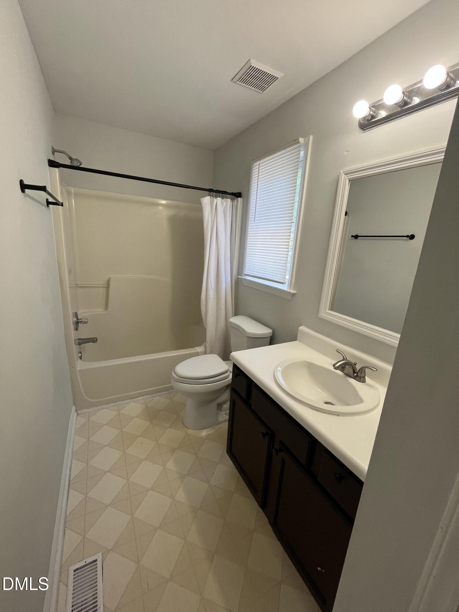 2036 Turtle Point Drive Raleigh, NC 27604 - Photo 12 of 29 a bathroom with a sink toilet a mirror and shower