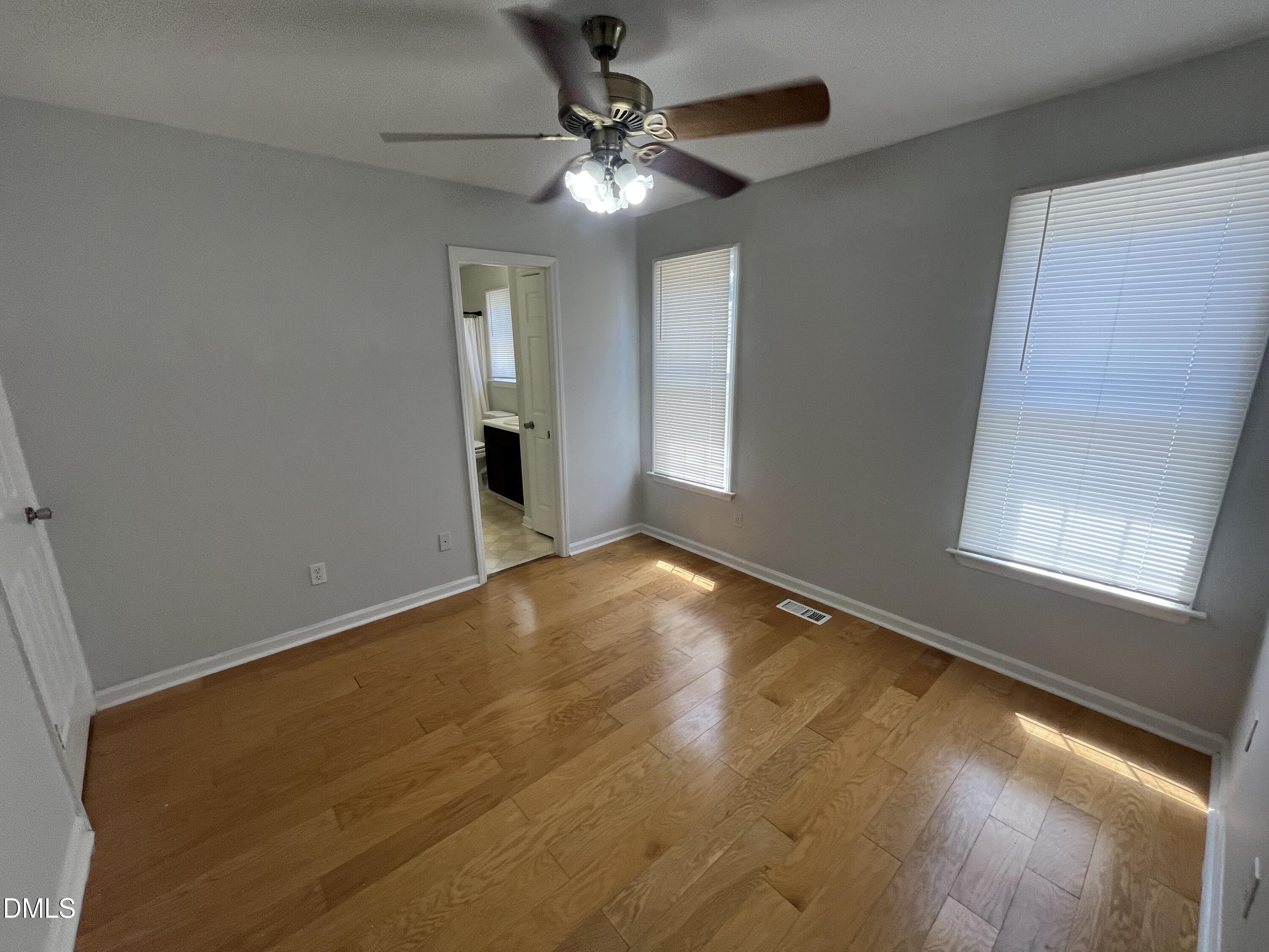 2036 Turtle Point Drive Raleigh, NC 27604 - Photo 14 of 29 an empty room with a chandelier fan and windows
