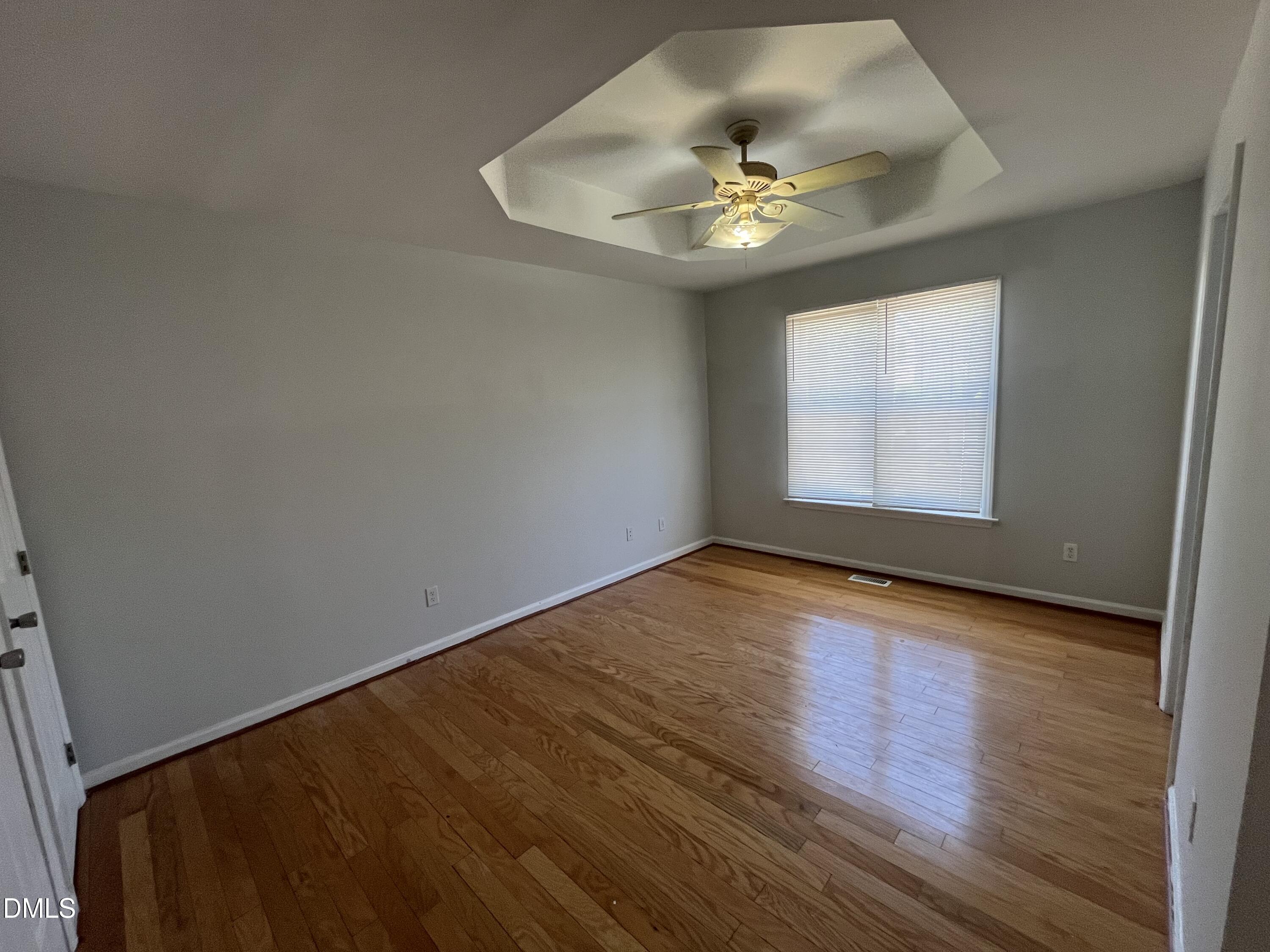 2036 Turtle Point Drive Raleigh, NC 27604 - Photo 15 of 29 an empty room with wooden floor and chandelier