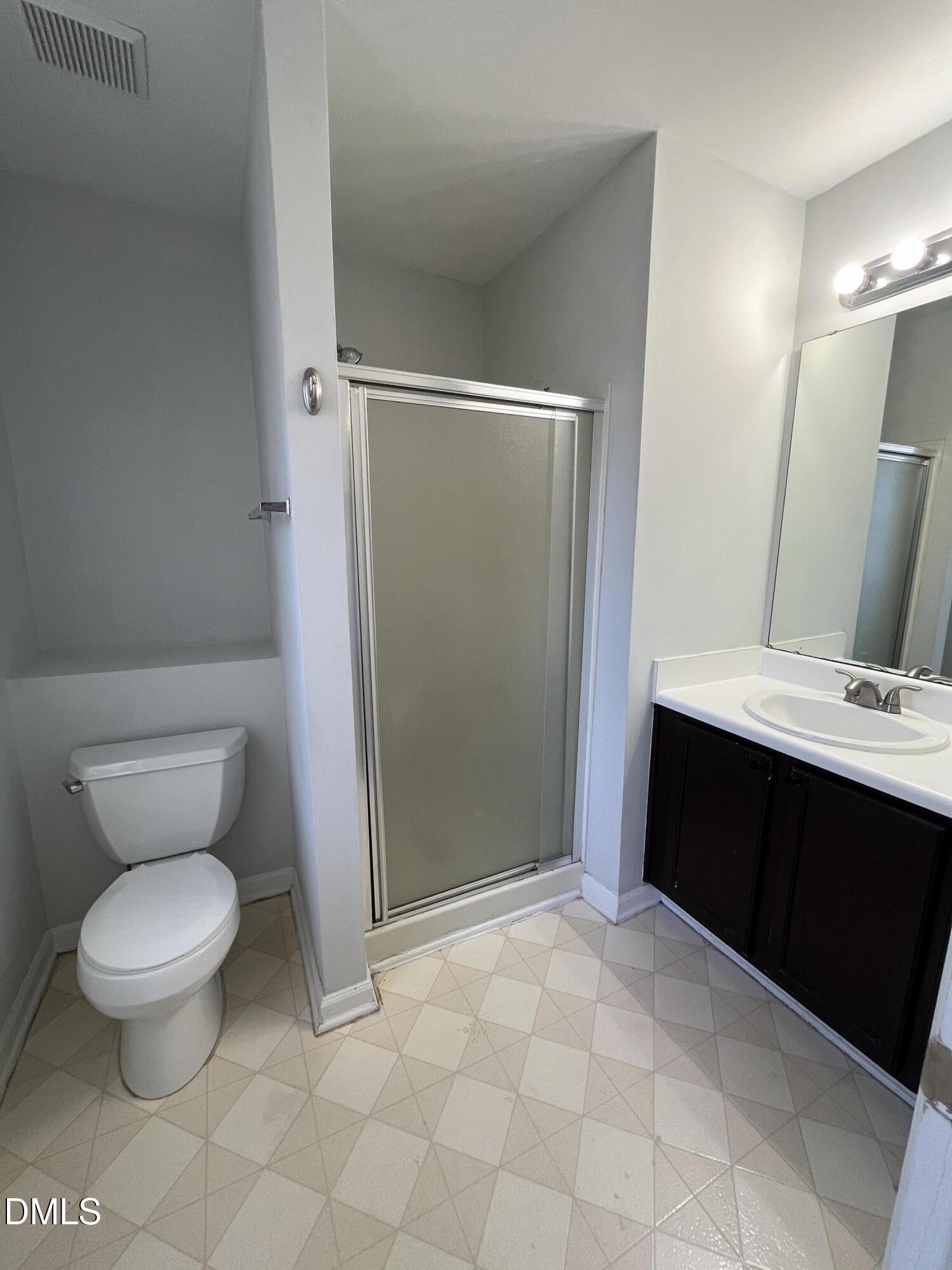 2036 Turtle Point Drive Raleigh, NC 27604 - Photo 17 of 29 a bathroom with a toilet a sink and a mirror