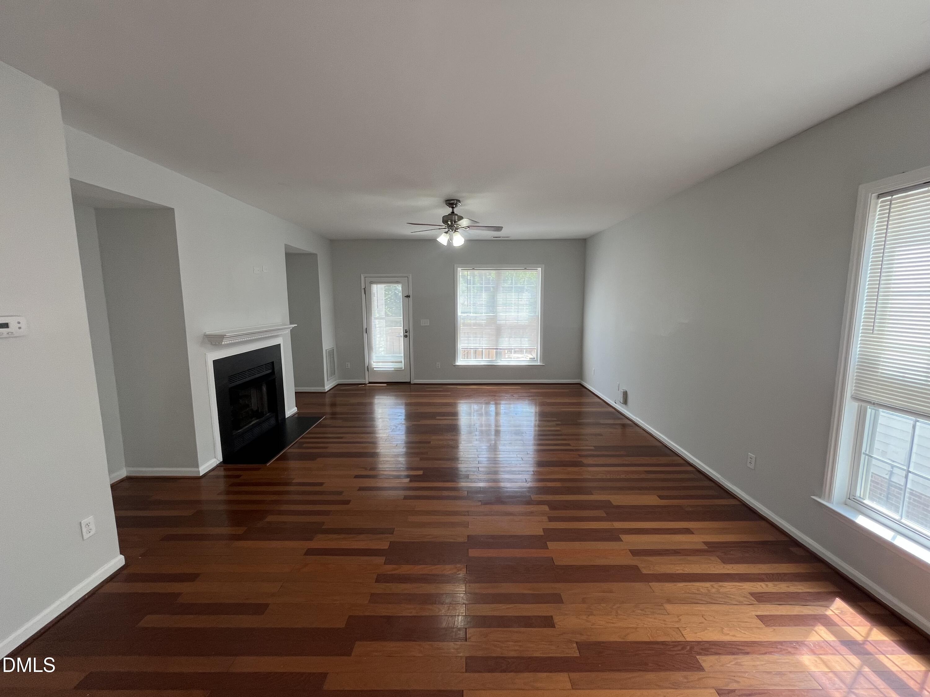 2036 Turtle Point Drive Raleigh, NC 27604 - Photo 2 of 29 a view of empty room with wooden floor and fireplace