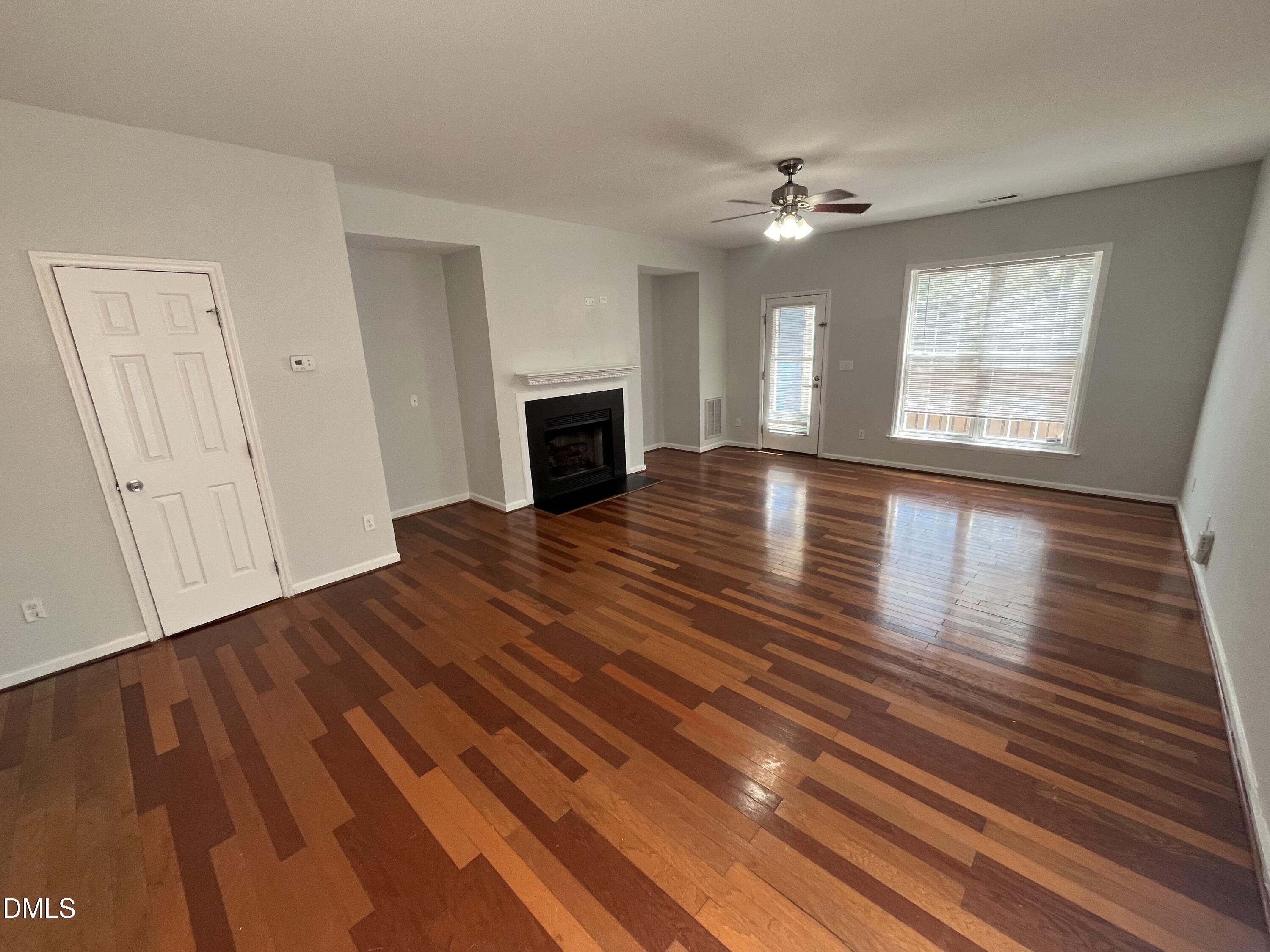 2036 Turtle Point Drive Raleigh, NC 27604 - Photo 3 of 29 a view of an empty room with wooden floor and a window
