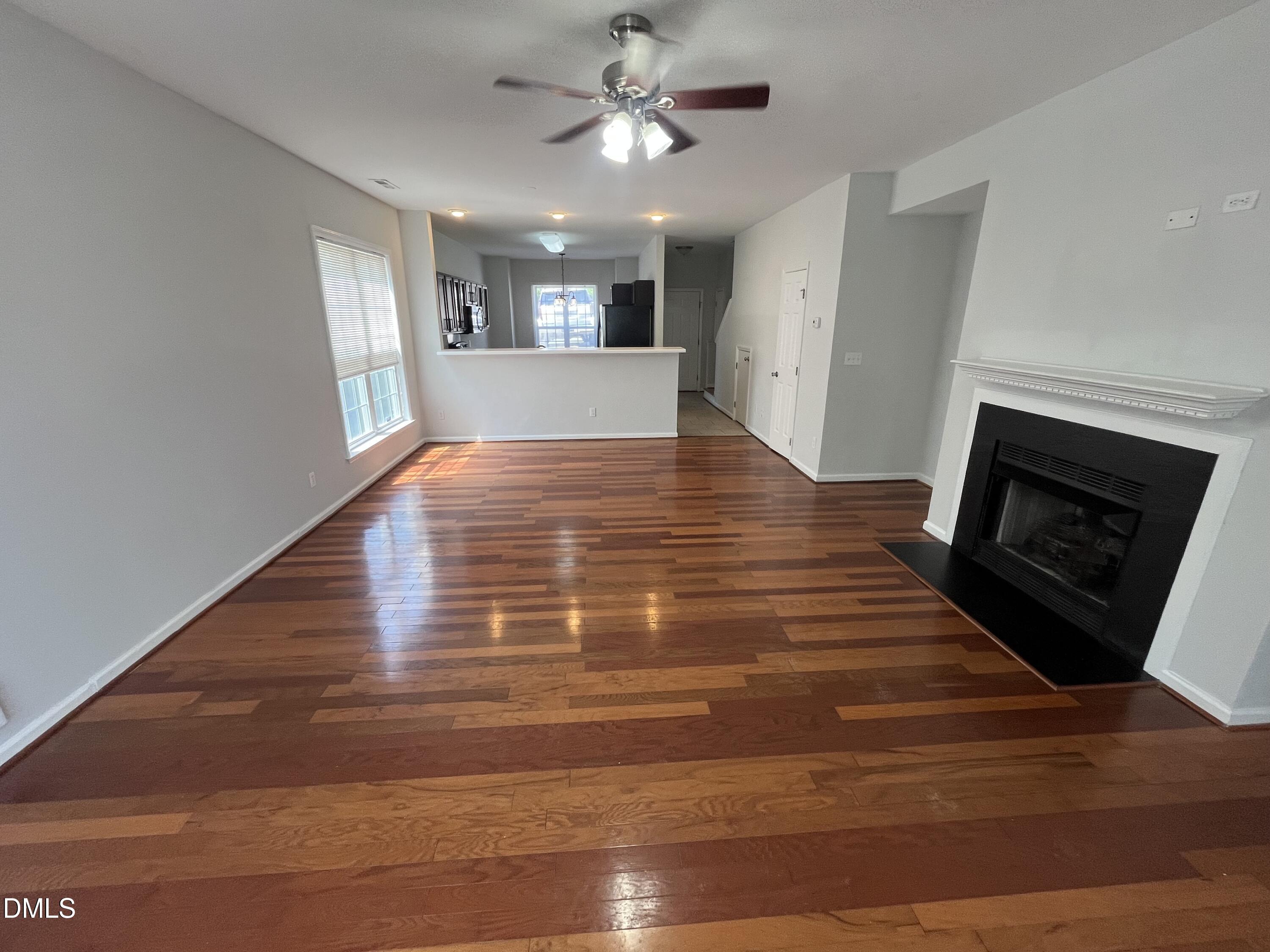 2036 Turtle Point Drive Raleigh, NC 27604 - Photo 4 of 29 a view of an empty room with window and wooden floor