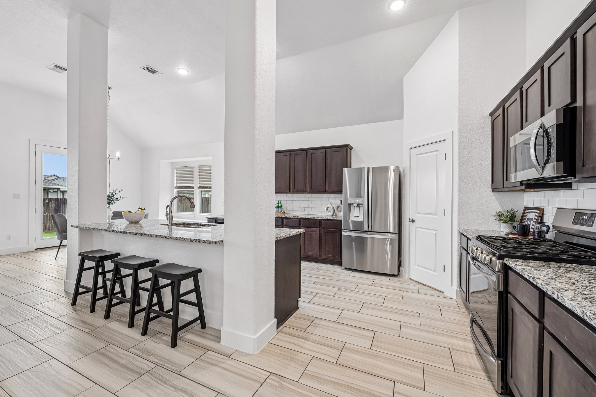 201 Potts Street Georgetown, TX 78628 - Photo 6 of 27 The oversized center island doubles as a breakfast bar, acting as the heart of the home's social hub.