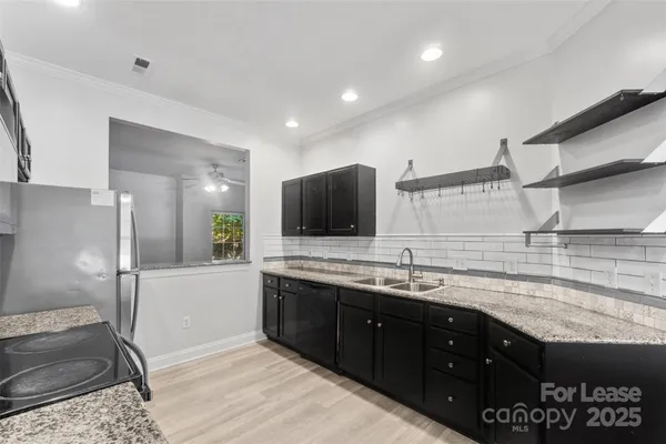 a kitchen with a sink and a refrigerator