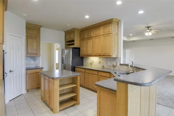 a kitchen with a sink appliances and cabinets