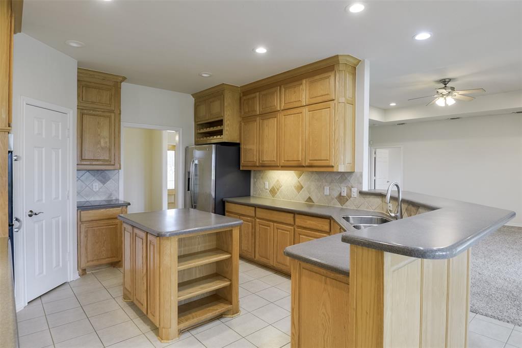 1066 W Road Waxahachie, TX 75165 - Photo 11 of 36 a kitchen with a sink appliances and cabinets