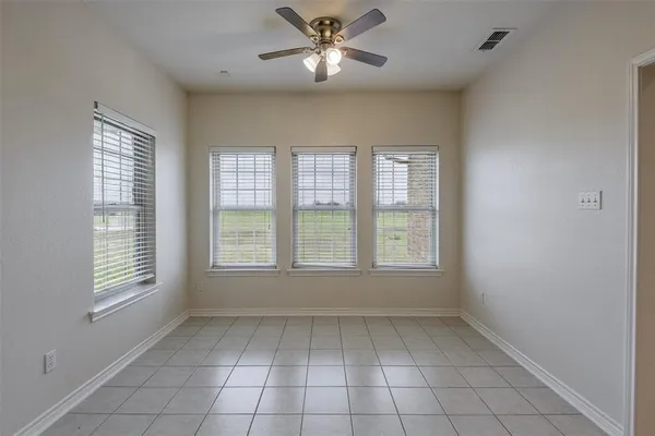 a view of an empty room with a window and a fan