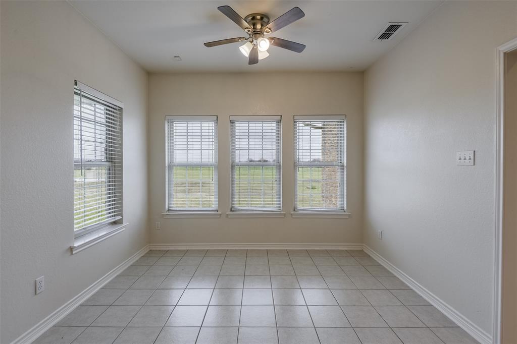 1066 W Road Waxahachie, TX 75165 - Photo 15 of 36 a view of an empty room with a window and a fan