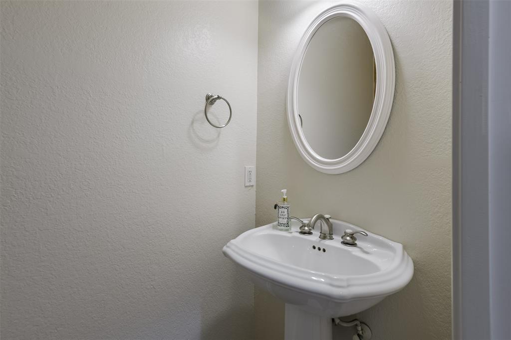 1066 W Road Waxahachie, TX 75165 - Photo 16 of 36 a bathroom with a sink and a mirror