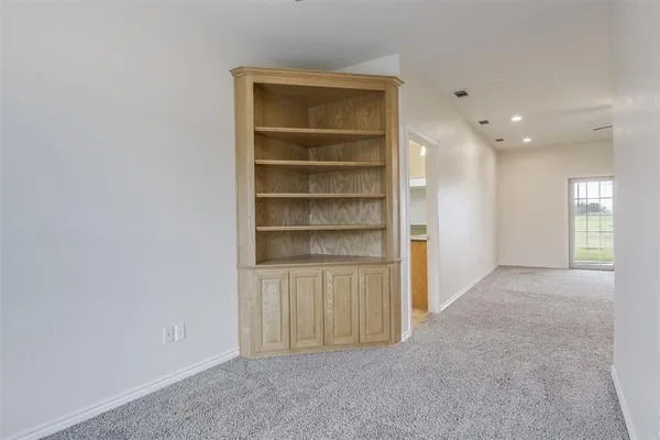 a view of an empty room and a window