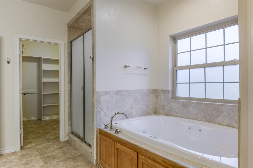1066 W Road Waxahachie, TX 75165 - Photo 21 of 36 a bathroom with a bathtub and a sink