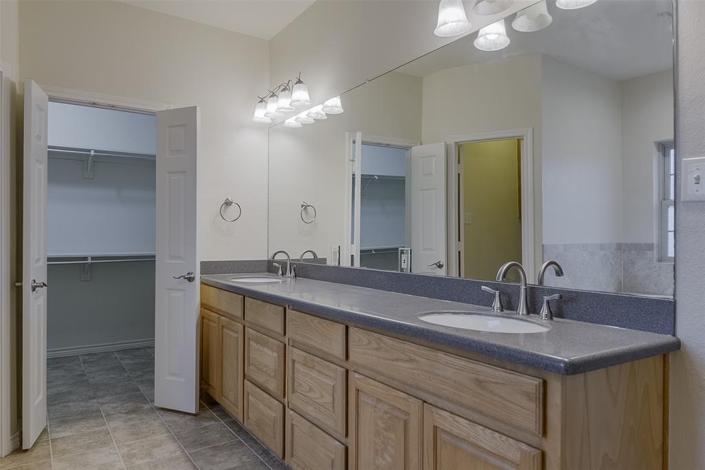 1066 W Road Waxahachie, TX 75165 - Photo 22 of 36 a bathroom with a double vanity sink and a mirror