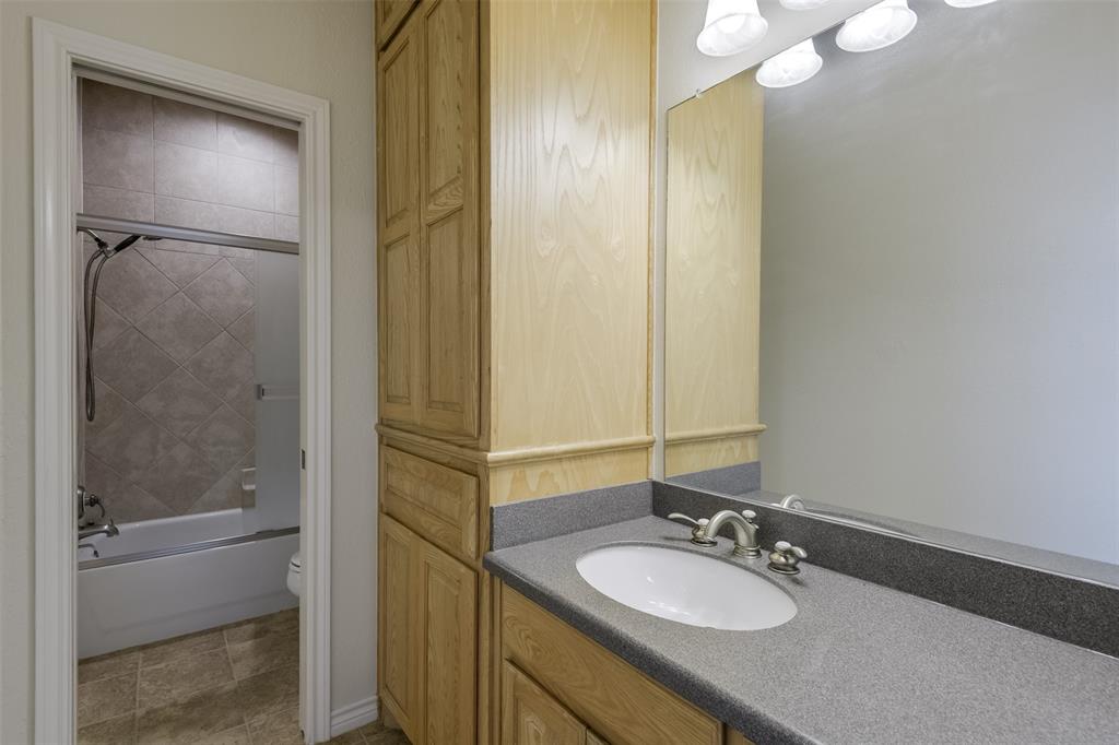 1066 W Road Waxahachie, TX 75165 - Photo 29 of 36 a bathroom with a granite countertop sink and a mirror
