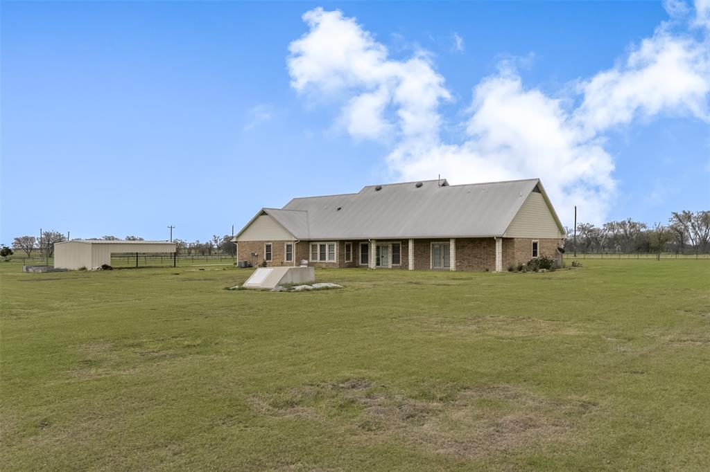 1066 W Road Waxahachie, TX 75165 - Photo 32 of 36 a front view of a house with a garden