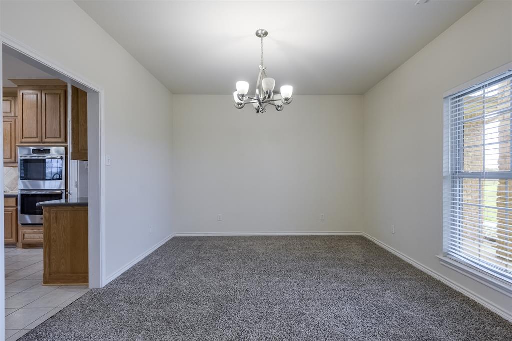 1066 W Road Waxahachie, TX 75165 - Photo 6 of 36 wooden floor in an empty room with a window